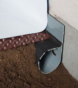 Closeup of a crawl space drainage system installed in Eastpointe